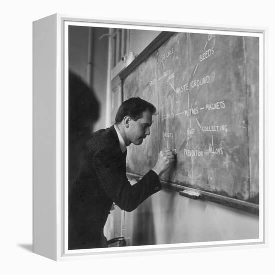 A Teacher Writing on a Blackboard at Northfield House Junior School, Leicester-Henry Grant-Framed Premier Image Canvas