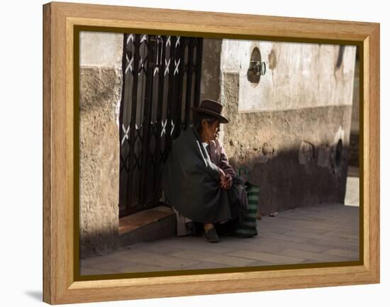 A Traditional Bolivian Woman Sits on a Doorstep in Potosi at Sunset-Alex Saberi-Framed Premier Image Canvas