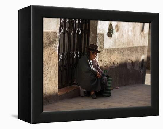 A Traditional Bolivian Woman Sits on a Doorstep in Potosi at Sunset-Alex Saberi-Framed Premier Image Canvas