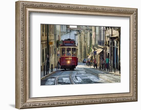 A tramway in Alfama district with the Motherchurch (Se Catedral) in the background. Lisbon, Portuga-Mauricio Abreu-Framed Photographic Print