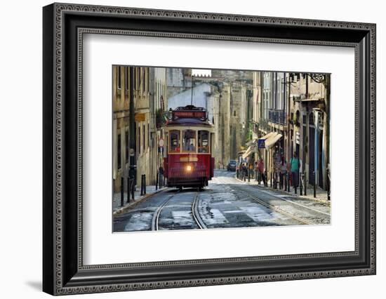 A tramway in Alfama district with the Motherchurch (Se Catedral) in the background. Lisbon, Portuga-Mauricio Abreu-Framed Photographic Print