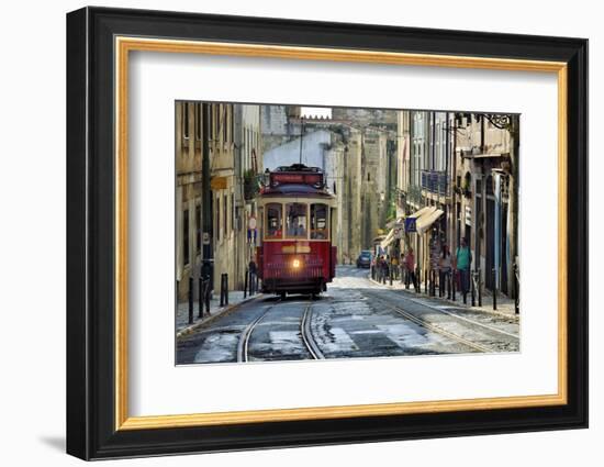 A tramway in Alfama district with the Motherchurch (Se Catedral) in the background. Lisbon, Portuga-Mauricio Abreu-Framed Photographic Print