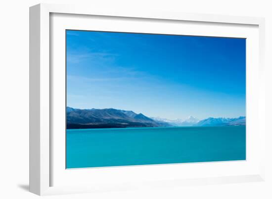 A turquoise blue lake with snow covered mountains in the distance, South Island, New Zealand-Logan Brown-Framed Photographic Print