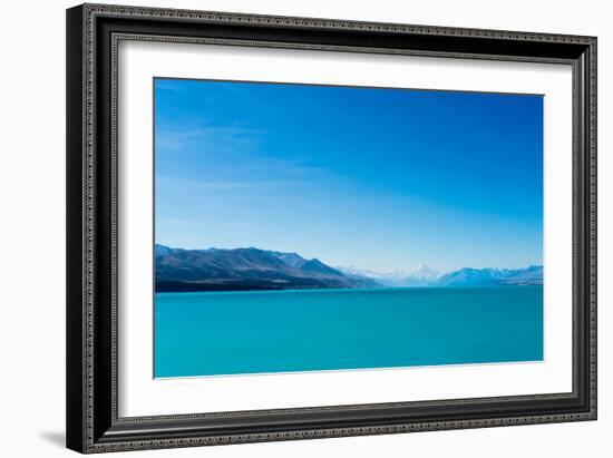 A turquoise blue lake with snow covered mountains in the distance, South Island, New Zealand-Logan Brown-Framed Photographic Print