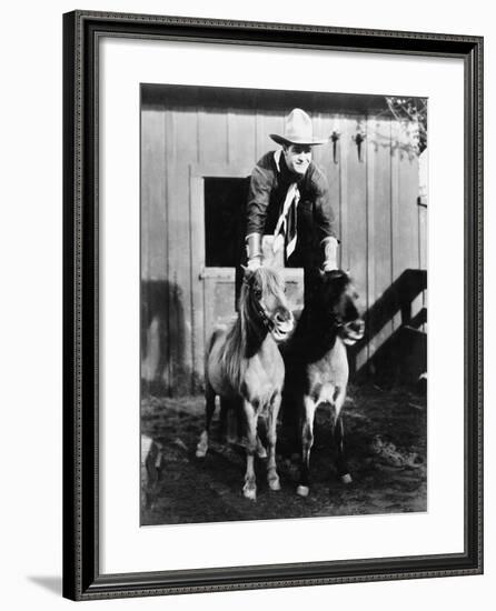 A Two Horse Power Ride, Cowboy Riding Two Ponies-null-Framed Photo