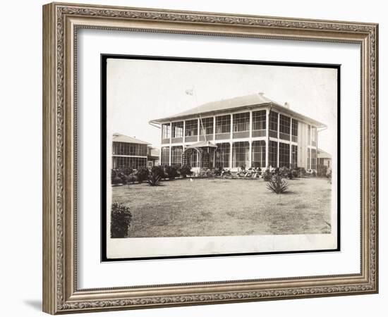 A Two-Story House Surrounded by Porches, with an American Flag Flying; in Panama During the…-Byron Company-Framed Giclee Print