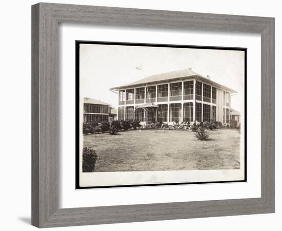 A Two-Story House Surrounded by Porches, with an American Flag Flying; in Panama During the…-Byron Company-Framed Giclee Print