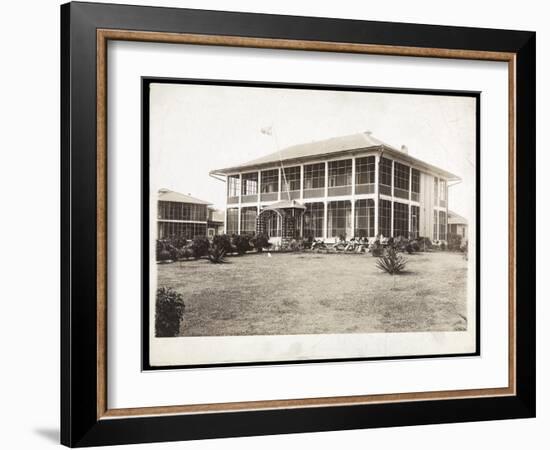 A Two-Story House Surrounded by Porches, with an American Flag Flying; in Panama During the…-Byron Company-Framed Giclee Print