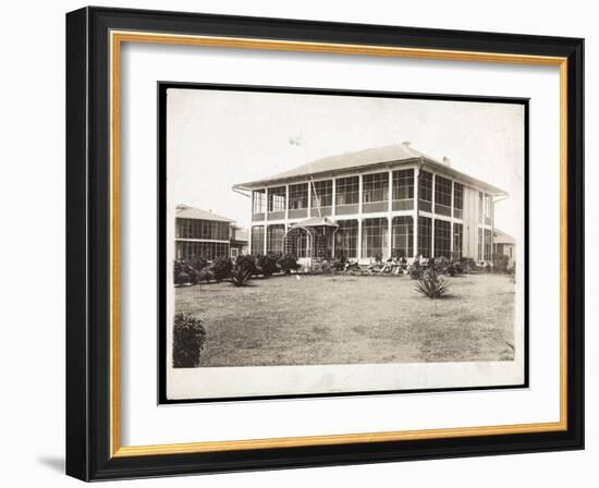 A Two-Story House Surrounded by Porches, with an American Flag Flying; in Panama During the…-Byron Company-Framed Giclee Print