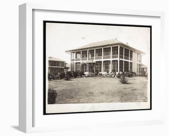 A Two-Story House Surrounded by Porches, with an American Flag Flying; in Panama During the…-Byron Company-Framed Premium Giclee Print