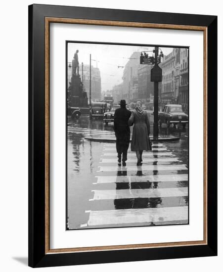 A Typical English Street on a Rainy Shopping Day: an Elderly Couple Use the Zebra Crossing-Henry Grant-Framed Photographic Print