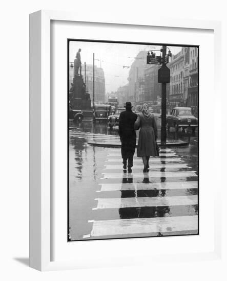 A Typical English Street on a Rainy Shopping Day: an Elderly Couple Use the Zebra Crossing-Henry Grant-Framed Photographic Print