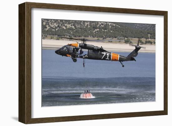 A U.S. Army Uh-60 Black Hawk Helicopter Collects Water from a Reservoir-null-Framed Photographic Print