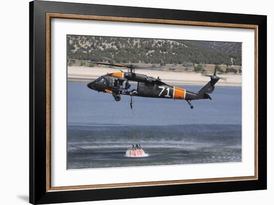 A U.S. Army Uh-60 Black Hawk Helicopter Collects Water from a Reservoir-null-Framed Photographic Print