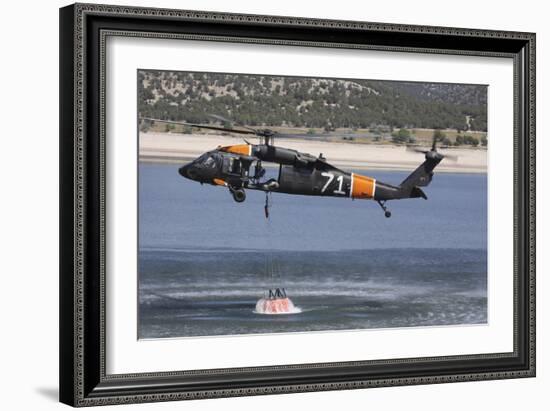 A U.S. Army Uh-60 Black Hawk Helicopter Collects Water from a Reservoir-null-Framed Photographic Print