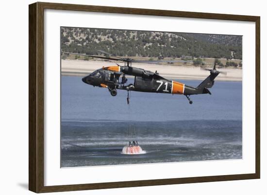 A U.S. Army Uh-60 Black Hawk Helicopter Collects Water from a Reservoir-null-Framed Photographic Print