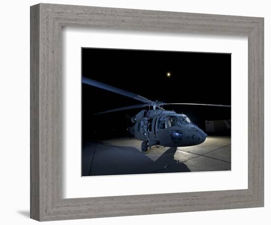 A UH-60 Black Hawk Helicopter Parked on the Flight Line under a Full Moon-null-Framed Photographic Print