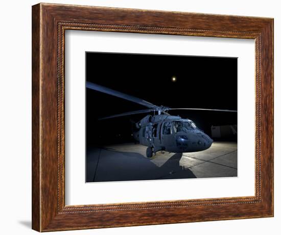 A UH-60 Black Hawk Helicopter Parked on the Flight Line under a Full Moon-null-Framed Photographic Print