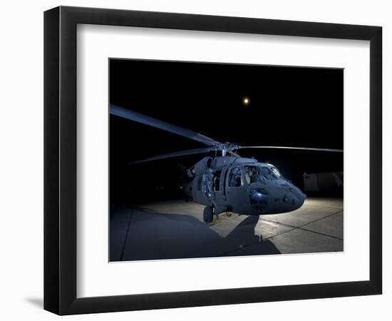 A UH-60 Black Hawk Helicopter Parked on the Flight Line under a Full Moon-null-Framed Photographic Print