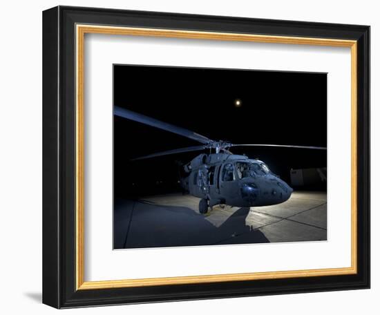 A UH-60 Black Hawk Helicopter Parked on the Flight Line under a Full Moon-null-Framed Photographic Print