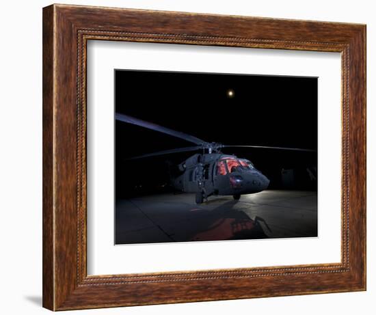 A UH-60 Black Hawk Helicopter Parked on the Flight Line under a Full Moon-null-Framed Photographic Print