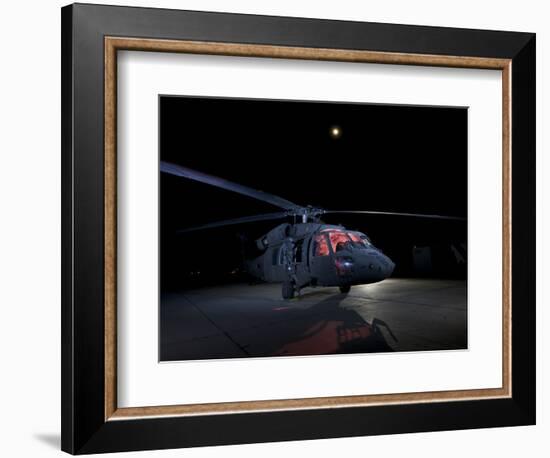 A UH-60 Black Hawk Helicopter Parked on the Flight Line under a Full Moon-null-Framed Photographic Print