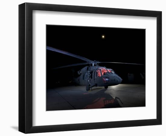 A UH-60 Black Hawk Helicopter Parked on the Flight Line under a Full Moon-null-Framed Photographic Print