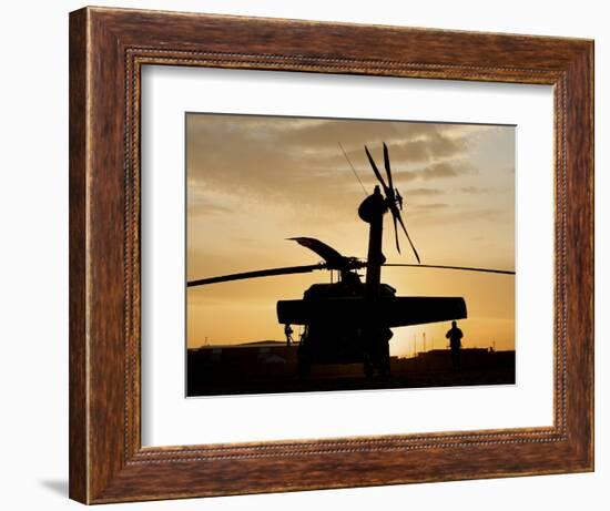 A UH-60L Black Hawk Helicopter Silhouetted by the Setting Sun-null-Framed Photographic Print