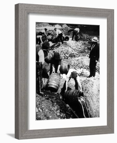 A Us Federal Agent Oversees the Destruction of Beer Kegs During the American Prohibition Era…-American Photographer-Framed Photographic Print