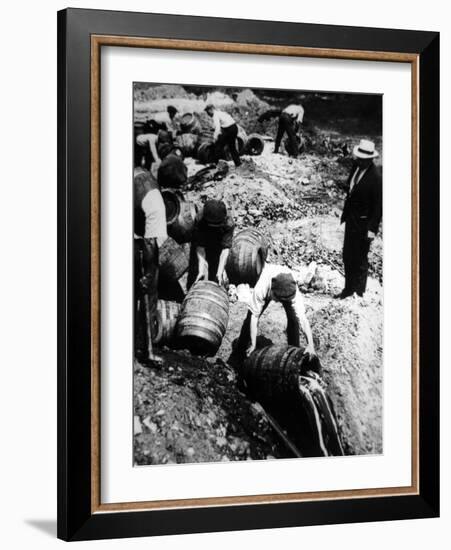 A Us Federal Agent Oversees the Destruction of Beer Kegs During the American Prohibition Era…-American Photographer-Framed Photographic Print