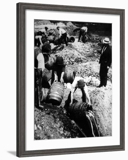 A Us Federal Agent Oversees the Destruction of Beer Kegs During the American Prohibition Era…-American Photographer-Framed Photographic Print