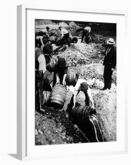 A Us Federal Agent Oversees the Destruction of Beer Kegs During the American Prohibition Era…-American Photographer-Framed Photographic Print