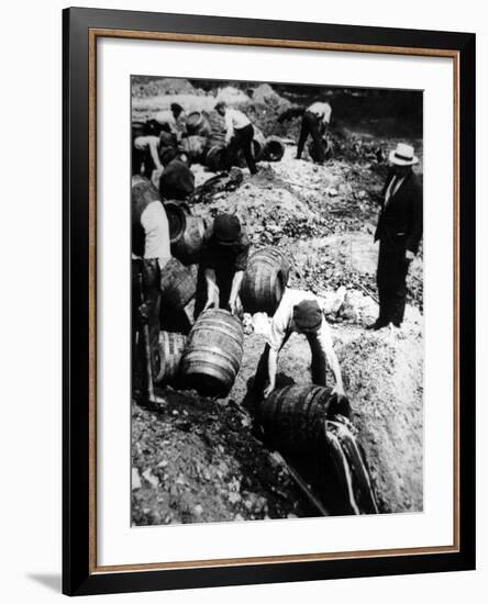 A Us Federal Agent Oversees the Destruction of Beer Kegs During the American Prohibition Era…-American Photographer-Framed Photographic Print