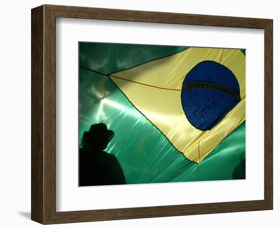 A Vendor Walks Behind a Big Brazilian Flag-null-Framed Photographic Print