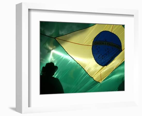 A Vendor Walks Behind a Big Brazilian Flag-null-Framed Photographic Print