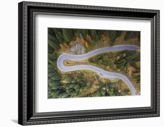 A view by drone of a winding road in the Dolomites, Italy-Julian Elliott-Framed Photographic Print