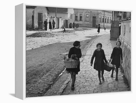 A View of Jewish Children Walking Through the Streets of their Ghetto-William Vandivert-Framed Premier Image Canvas
