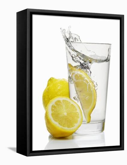 A Wedge of Lemon Falling into a Glass of Water-Kröger & Gross-Framed Premier Image Canvas