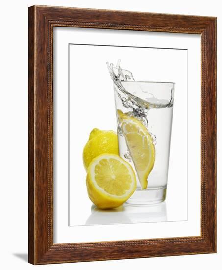 A Wedge of Lemon Falling into a Glass of Water-Kröger & Gross-Framed Photographic Print