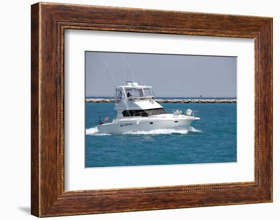 A White Sport Fishing Boat, Flying the US Yacht Ensign, Heads towards the Open Sea.-Gary Blakeley-Framed Photographic Print