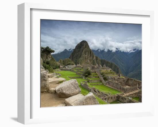 A wide angle photo of Macchu Pichu at sunrise with dramatic clouds in the distance.-Alex Saberi-Framed Photographic Print