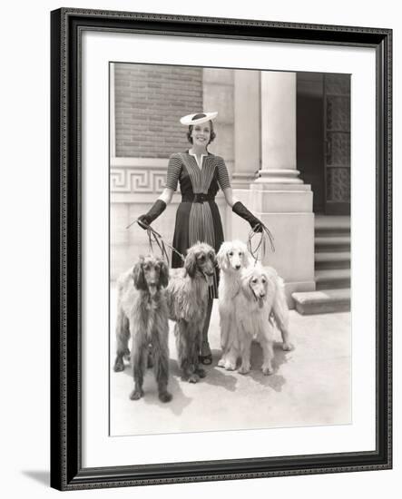 A Woman and Her Four Afghan Hounds-null-Framed Photo