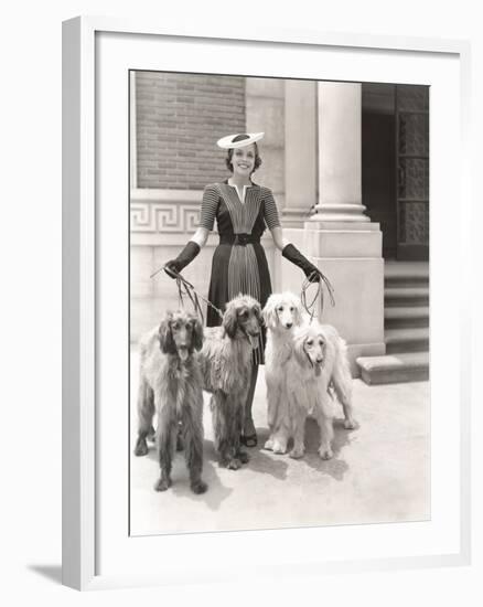 A Woman and Her Four Afghan Hounds-null-Framed Photo