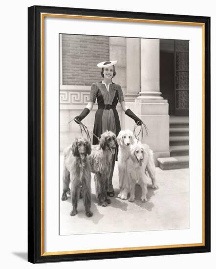 A Woman and Her Four Afghan Hounds-null-Framed Photo