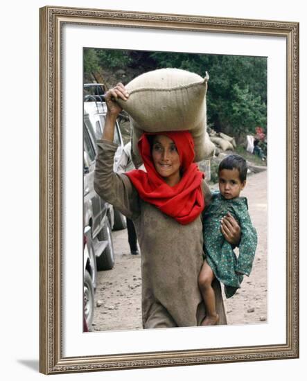 A Woman Carries Relief Supplies at Jula Village, Near Uri, India-null-Framed Photographic Print