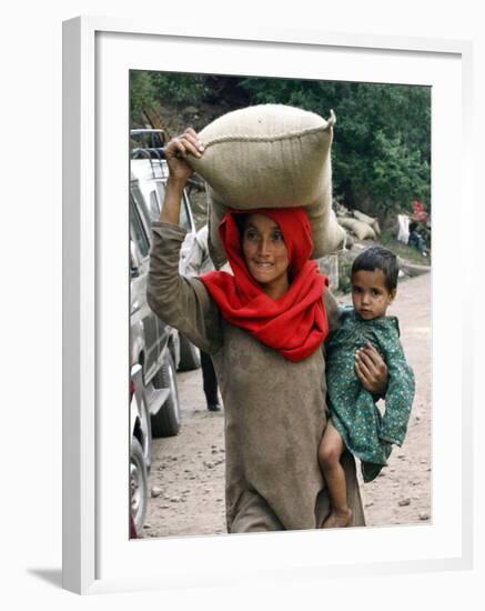 A Woman Carries Relief Supplies at Jula Village, Near Uri, India-null-Framed Photographic Print