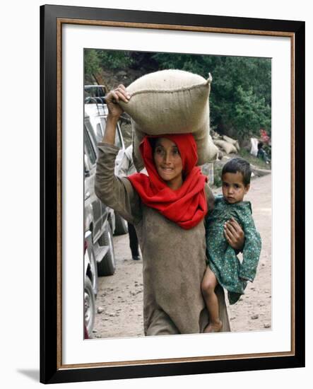 A Woman Carries Relief Supplies at Jula Village, Near Uri, India-null-Framed Photographic Print