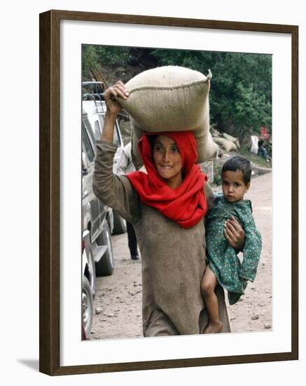 A Woman Carries Relief Supplies at Jula Village, Near Uri, India-null-Framed Photographic Print