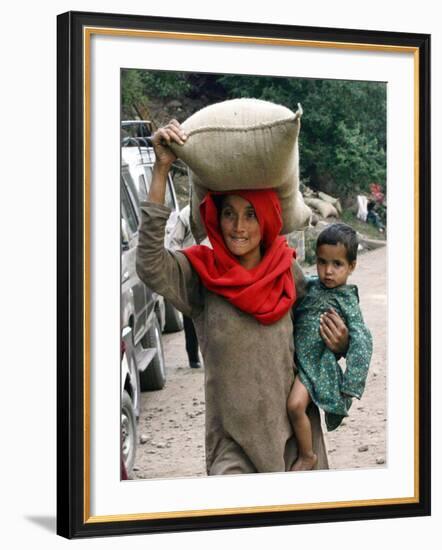 A Woman Carries Relief Supplies at Jula Village, Near Uri, India-null-Framed Photographic Print