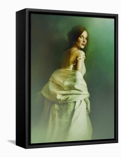 A Woman in a White Evening Dress, Standing by the Wall and Looking at the Viewer-Malgorzata Maj-Framed Premier Image Canvas